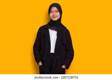 Portrait Young Asian Muslim Woman In Head Scarf Isolated On Yellow Background
