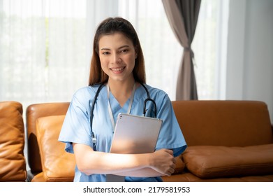 Portrait Of A Young Asian Nurse Or Caregiver At Home.Concept Healthcare, Profession, People And Medicine 