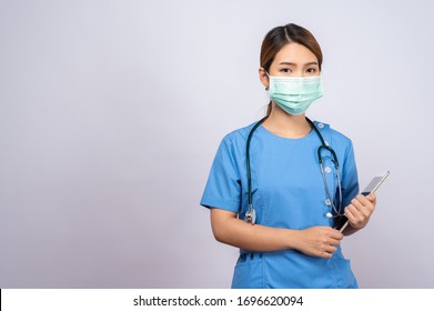 Portrait Of Young Asian Nurse Wearing Surgical Mask