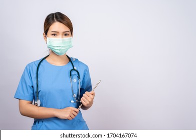 Portrait Of Young Asian Nurse Wearing Surgical Mask