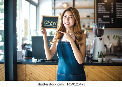 Portrait Young Asian Woman Barista Feeling Happy Smiling At Urban Cafe. Small Business Owner Korean Girl In Apron Relax Toothy Smile