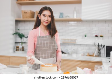 Portrait Young Asian Woman Cooking And Decoration Cake With Cream. Pastry Chef In The Kitchen Decorating Birthday Cake. Teacher Instructor Cake Class Online Course, Cooking And Pastry Skills