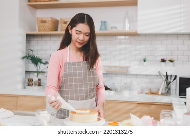 Portrait Young Asian Woman Cooking And Decoration Cake With Cream. Pastry Chef In The Kitchen Decorating Birthday Cake. Teacher Instructor Cake Class Online Course, Cooking And Pastry Skills