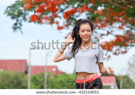 portrait of young Asian woman exercise in nature garden 