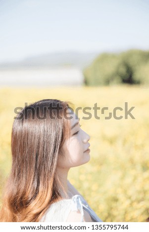 Similar – Junge Frau genießt die Sonne auf einer grünen Wiese