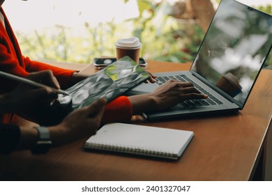 Portrait of Young Asian woman hand freelancer is working her job on computer tablet in modern office. Doing accounting analysis report real estate investment data, Financial and tax systems concept. - Powered by Shutterstock