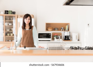 Portrait Of Young Asian Woman In The Kitchen