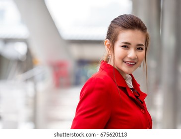 Portrait Young Asian Woman In Red Suit, Flight Attendant/air Hostage In Airport