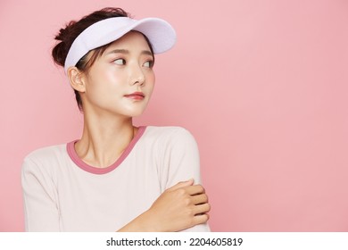 Portrait of young Asian woman in sporty fashion on pink background - Powered by Shutterstock