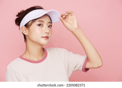 Portrait of young Asian woman in sporty fashion on pink background - Powered by Shutterstock