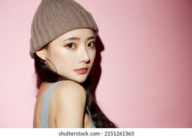 Portrait Of Young Asian Woman In Street Fashion On Pink Background