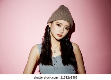 Portrait Of Young Asian Woman In Street Fashion On Pink Background