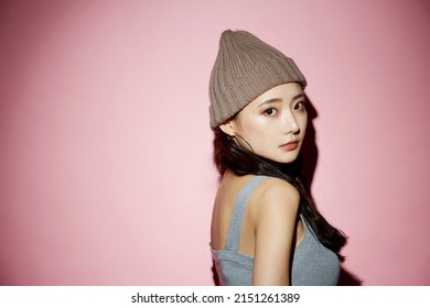 Portrait Of Young Asian Woman In Street Fashion On Pink Background