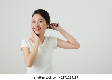 Portrait Of Young Asian Woman Twisting Hair And Touching Her Face