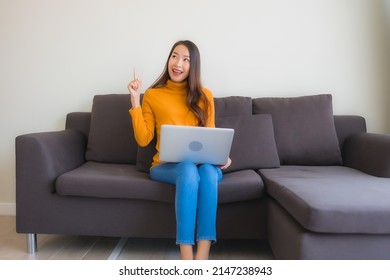 Portrait Young Asian Woman Using Laptop Computer Note Book On Sofa For Work In Living Room