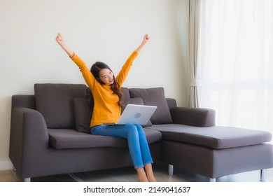 Portrait Young Asian Woman Using Laptop Computer Note Book On Sofa For Work In Living Room