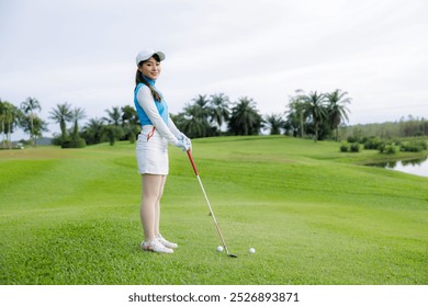 portrait of young asian women professional golfers stand and pose looking at camera and smiling taking photo at the golf course, activities on weekend concept, - Powered by Shutterstock