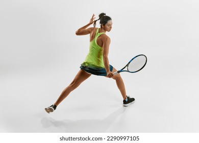 Portrait of young athletic woman, professional female tennis player training against white studio background. Game. Concept of professional sport, movement, health, action, competition. Ad - Powered by Shutterstock