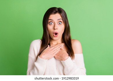 Portrait of young attractive amazed shocked surprised girl hear unexpected information isolated on green color background - Shutterstock ID 1912983319