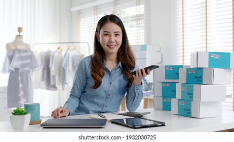 Portrait Young Attractive Asia Female Owner Startup Business Look At Camera Work Happy With Box At Home Prepare Parcel Delivery In Sme Supply Chain, Procurement, Omnichannel Commerce Online Concept.