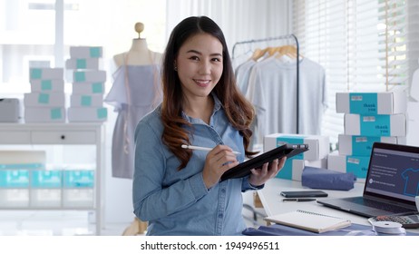 Portrait Young Attractive Asia Female Owner Startup Business Look At Camera Work Happy With Box At Home Prepare Parcel Delivery In Sme Supply Chain, Procurement, Omnichannel Commerce Online Concept.