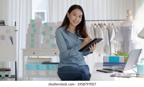 Portrait Young Attractive Asia Female Owner Startup Business Look At Camera Work Happy With Box At Home Prepare Parcel Delivery In Sme Supply Chain, Procurement, Omnichannel Commerce Online Concept.