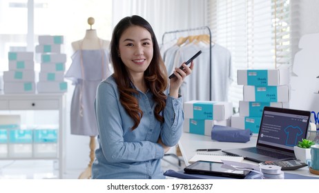 Portrait Young Attractive Asia Female Owner Startup Business Look At Camera Work Happy With Box At Home Prepare Parcel Delivery In Sme Supply Chain, Procurement, Omnichannel Commerce Online Concept.