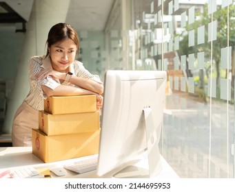 Portrait Young Attractive Asia Female Owner Startup Business  Work Happy With Box At Home Prepare Parcel Delivery In Sme Supply Chain, Procurement, Omnichannel Commerce Online Concept.
