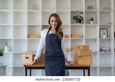 Portrait Young Attractive Asia Female Owner Startup Business Look At Camera Work Happy With Box At Home Prepare Parcel Delivery In Sme Supply Chain, Procurement, Omnichannel Commerce Online Concept.