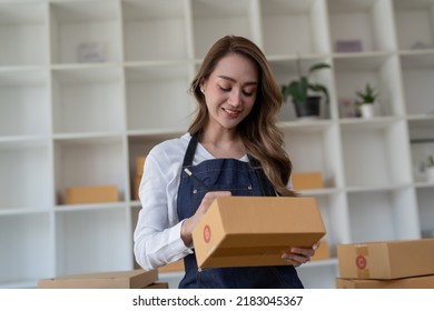 Portrait Young Attractive Asia Female Owner Startup Business Look At Camera Work Happy With Box At Home Prepare Parcel Delivery In Sme Supply Chain, Procurement, Omnichannel Commerce Online Concept.