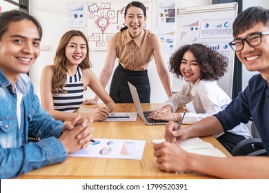 Portrait Of Young Attractive Asian Team Smile And Look At Camera In Financial Performance Or Organization Productivity Meeting, Career Or Job Concept With Feeling Happy And Cheerful In Casual Outfit.