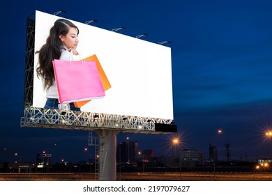 Portrait Of Young Attractive Beautiful Woman Hold The Shopping Bags Advertise On Billboard Blank For Outdoor Advertising Poster Or Blank Billboard For Advertisement