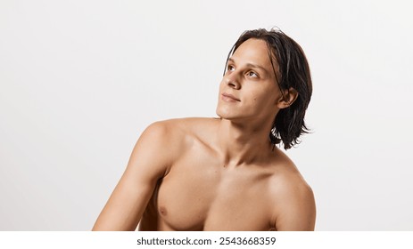 Portrait of young attractive brunette man with wet hair posing shirtless against white studio background. Concept of natural beauty, fashion, cosmetic product, male health. Ad - Powered by Shutterstock