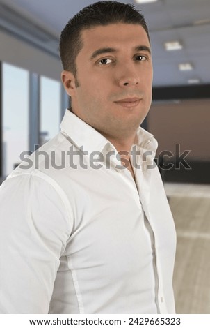 Portrait of young attractive business man in white shirt