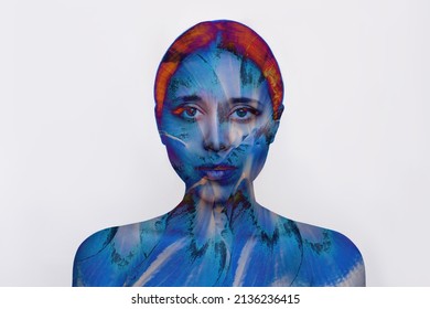 Portrait Of A Young Attractive Caucasian Woman With Color Blue Abstraction On The Skin Isolated On A White Background. Trendy Collage In Magazine Style. Contemporary Art. Modern Design