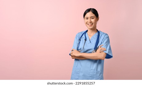 Portrait of young attractive doctor standing and have her arms crossed against pink isolated background.  - Powered by Shutterstock