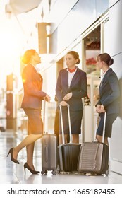 Portrait Of Young Attractive Flight Attendants Talking While Standing In Airport