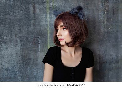 Portrait of a young attractive girl wearing cat ears cosplay