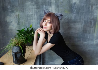 Portrait of a young attractive girl wearing cat ears cosplay