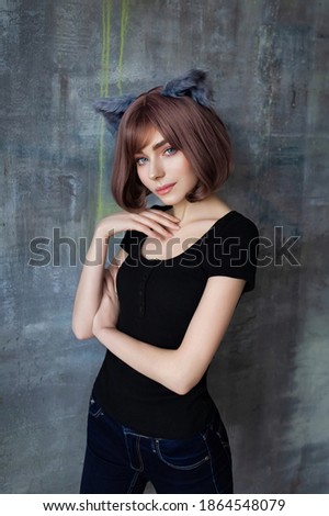 Portrait of a young attractive girl wearing cat ears cosplay