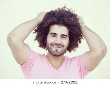 Portrait of young attractive guy with long curly hair