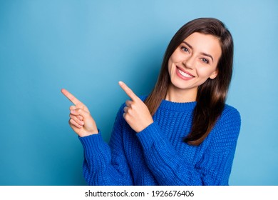 Portrait of young attractive happy positive good mood girl smiling pointing finger copyspace isolated on blue color background
