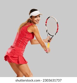 Portrait of young attractive happy tennis player posing with racket on gray background, the photo conveys a sense of youth passion for playing sports and the dedication to improving skills. - Powered by Shutterstock