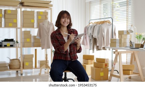 Portrait Young Attractive Hipster Asia Female Owner Startup Look At Camera Work Happy With Box At Home Prepare Parcel Delivery In Sme Supply Chain, Procurement, Omnichannel Ecommerce Online Concept.
