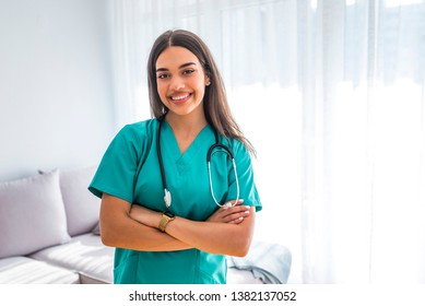 Portrait Of Young Attractive Smiling Nurse. Hoome Nurse. Caucasian Woman Working In Nursing Home. Beautiful Young Nurse Woman Wearing Uniform And Stethoscope