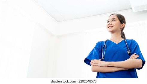 Portrait Of Young Attractive Smiling Nurse.Asian Woman Working In Nursing Home. Beautiful Young Nurse Woman Wearing Uniform And Stethoscope.Surgery Expert For Plastic Medical.COnfident In Medical.