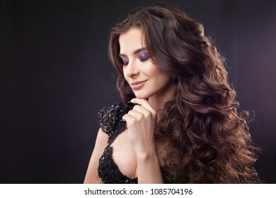 Portrait of a young attractive woman with gorgeous curly hair. Attractive brunette. Close up - Shutterstock ID 1085704196