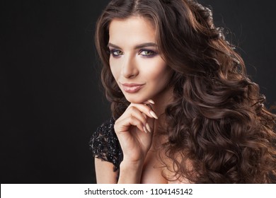 Portrait of a young attractive woman with gorgeous curly hair. Attractive brunette. Close up - Shutterstock ID 1104145142