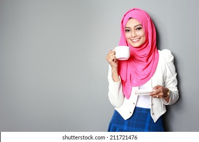 portrait of young attractive woman having a cup of tea