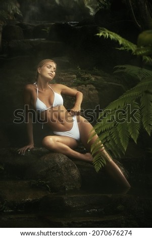 Portrait of young attractive woman having good time in jungle